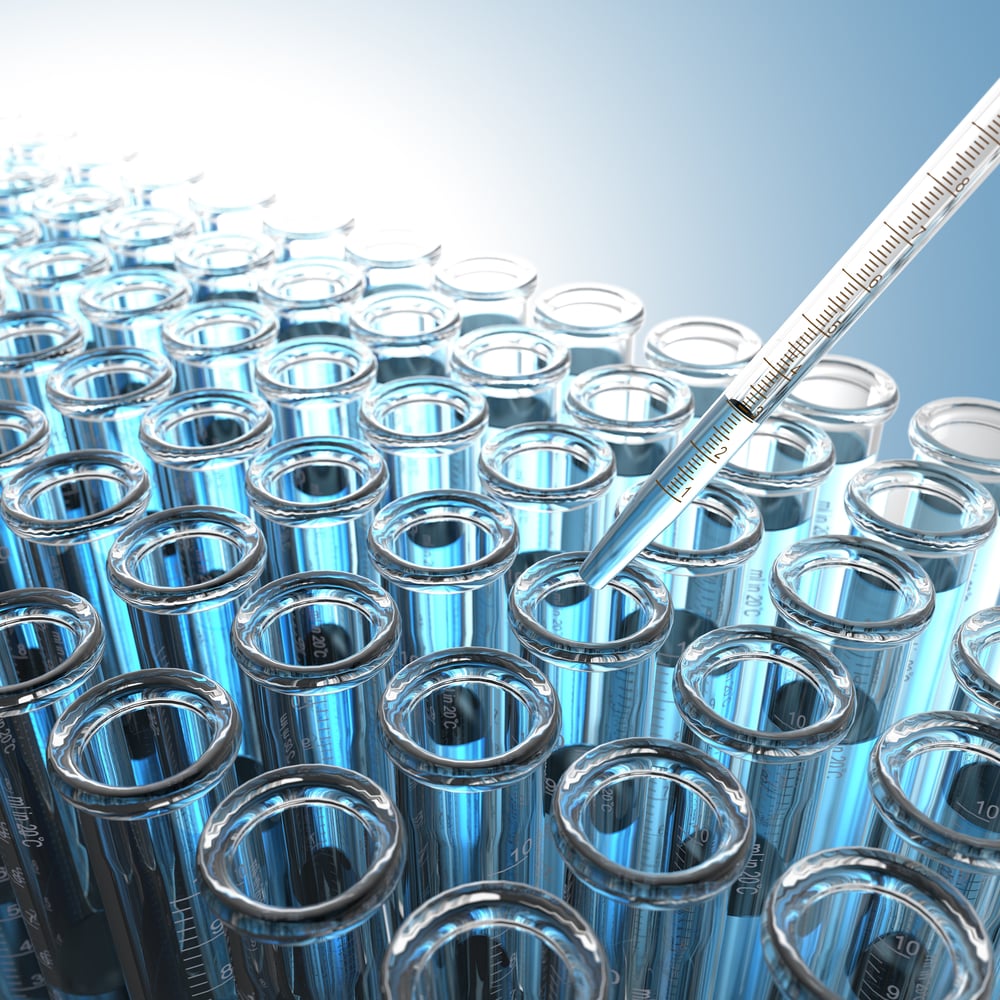 Laboratory Pipette with Blue Liquid Over Glass Test Tubes.-1 Laboratory Pipette with Blue Liquid Over Glass Test Tubes.-1
